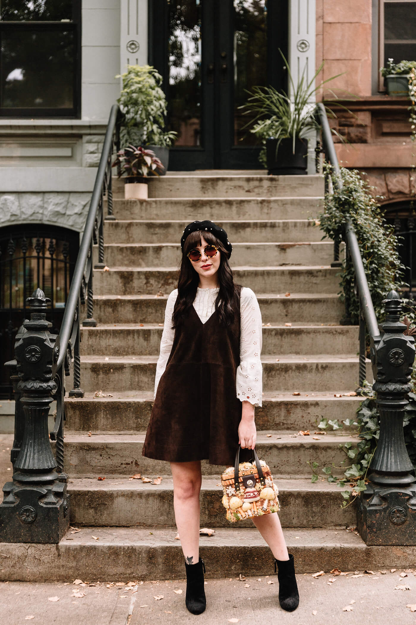 woman wearing free people suede jumper boots and a hat for Fall Outfit Roundup