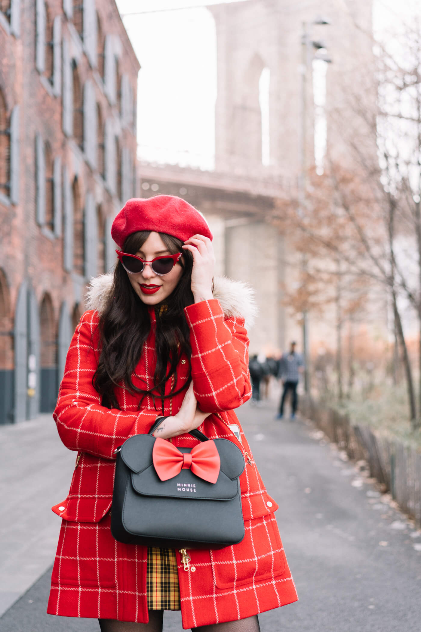 Evelyn Bourdon wearing a red checkered parka, vintage yellow plaid dress, red beret, minnie mouse bag, betty and veronica sunglasses, and black suede strappy block heels