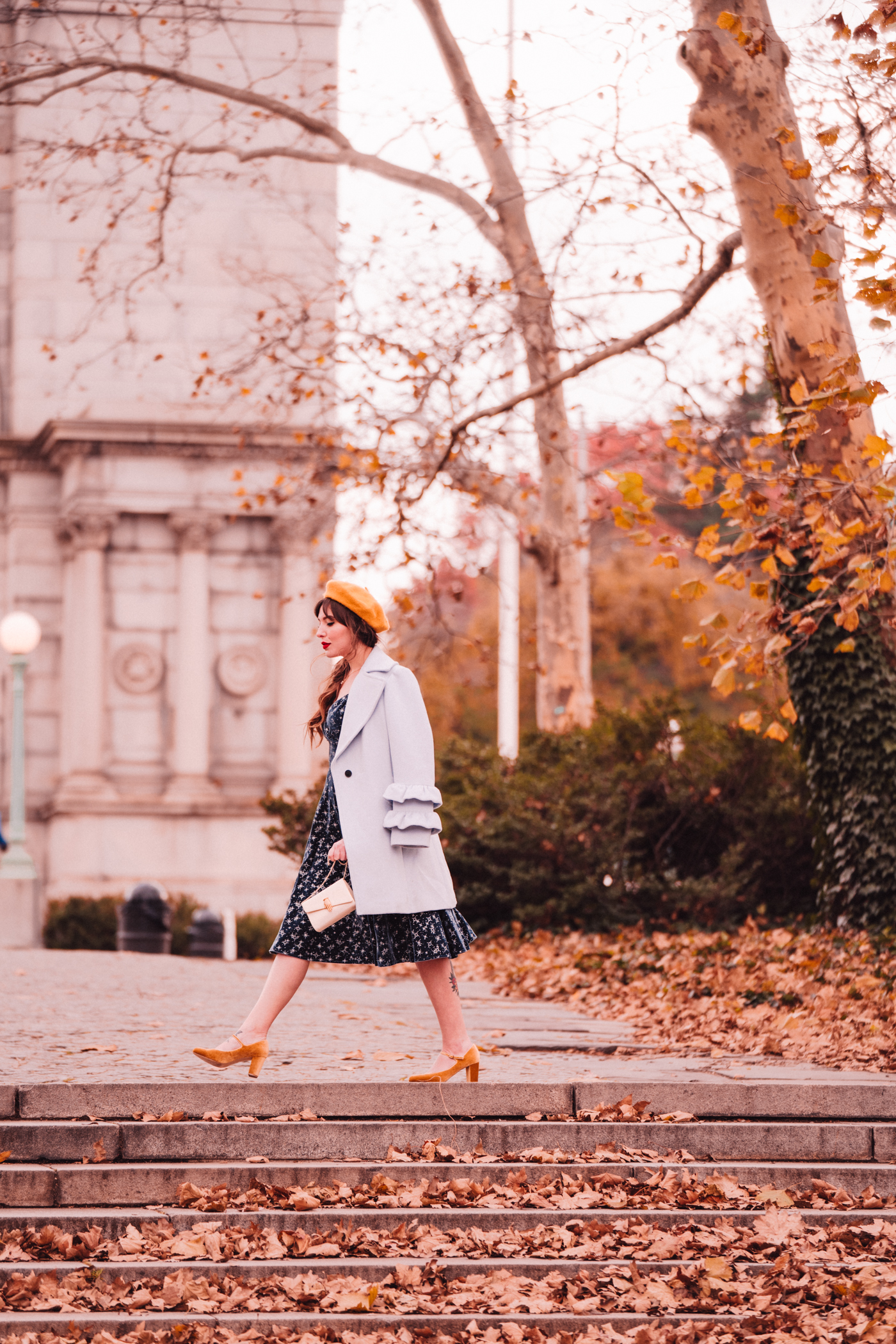 woman in blue dress for blue christmas wearing coat and yellow shoes