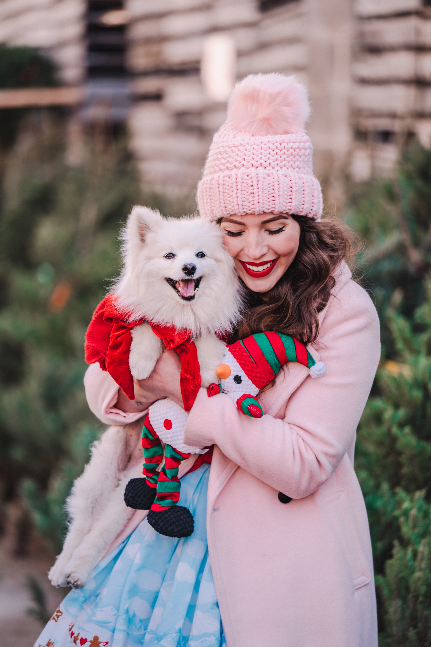 woman carrying her dog and sharing Under My Tree