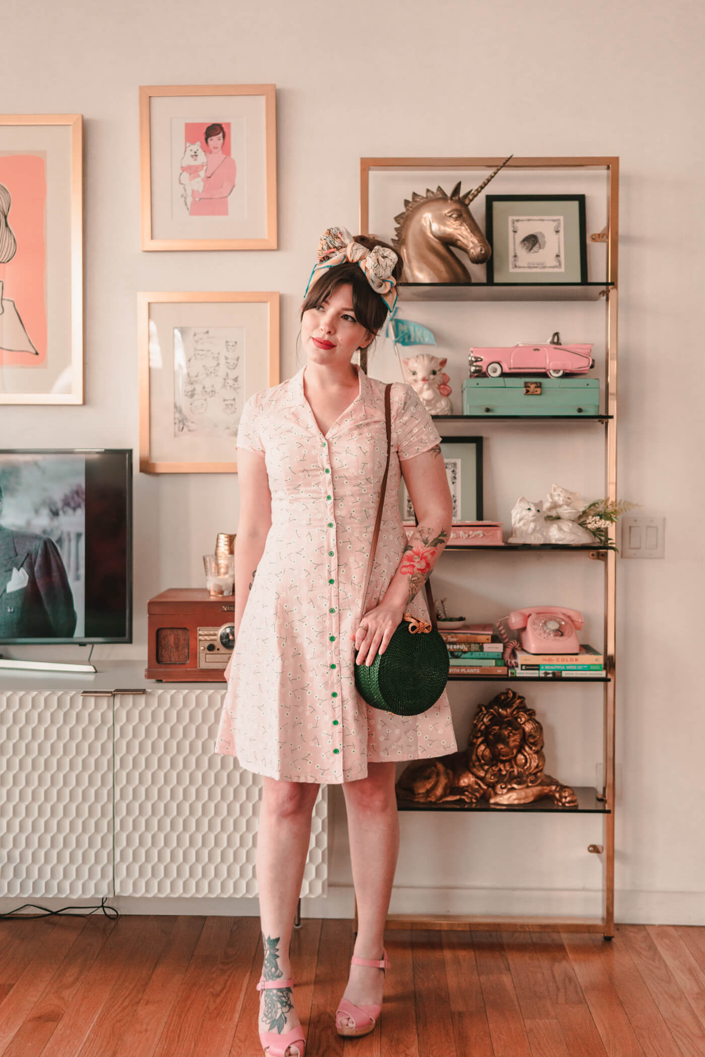 woman in button down dress and green bag for against the current