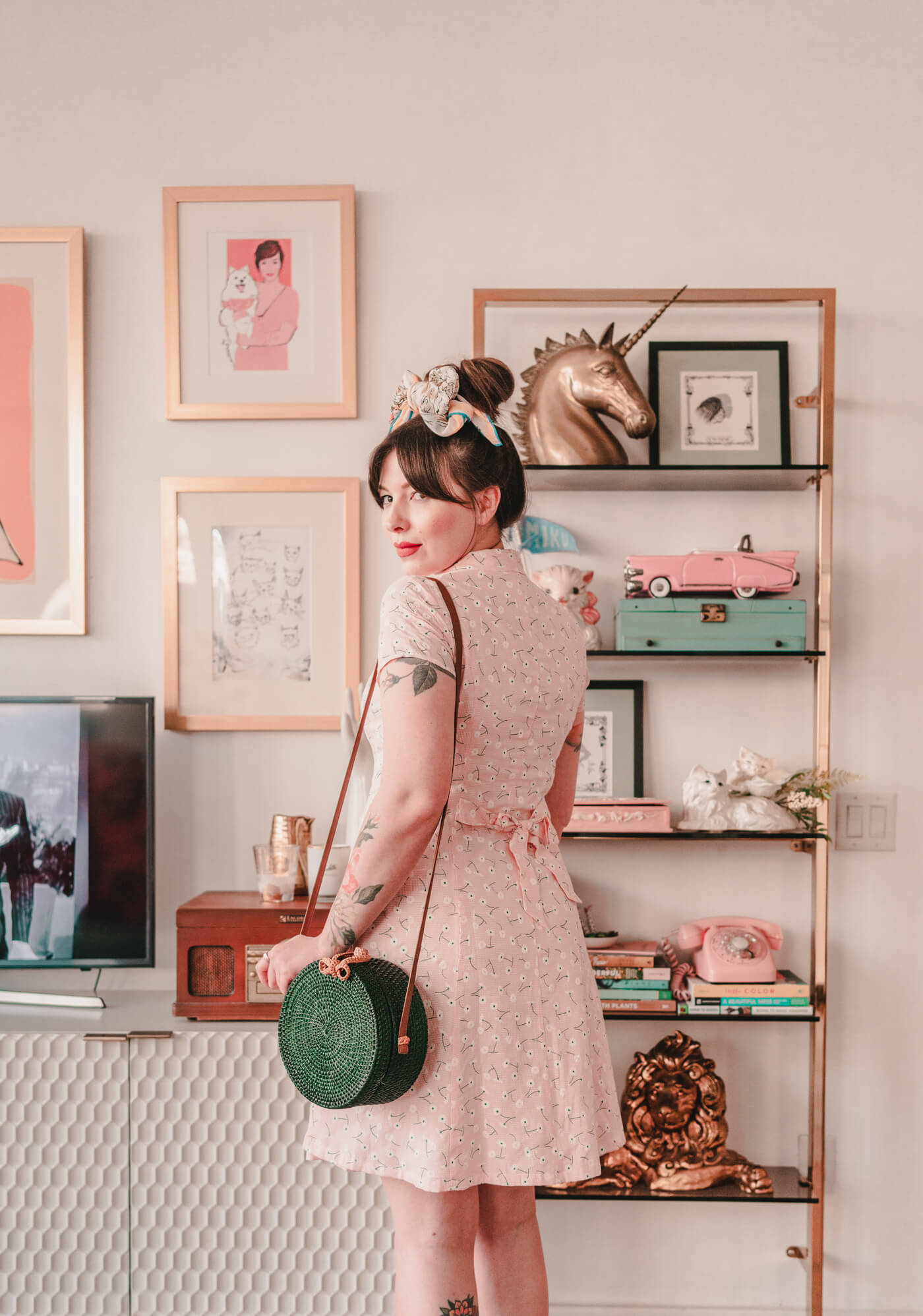 woman in pink button down dress and green bag for against the current