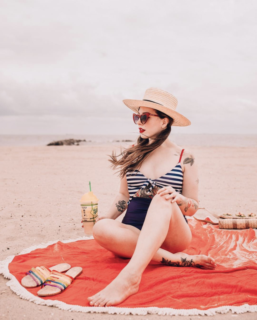 woman wearing one piece swimsuit at the beach