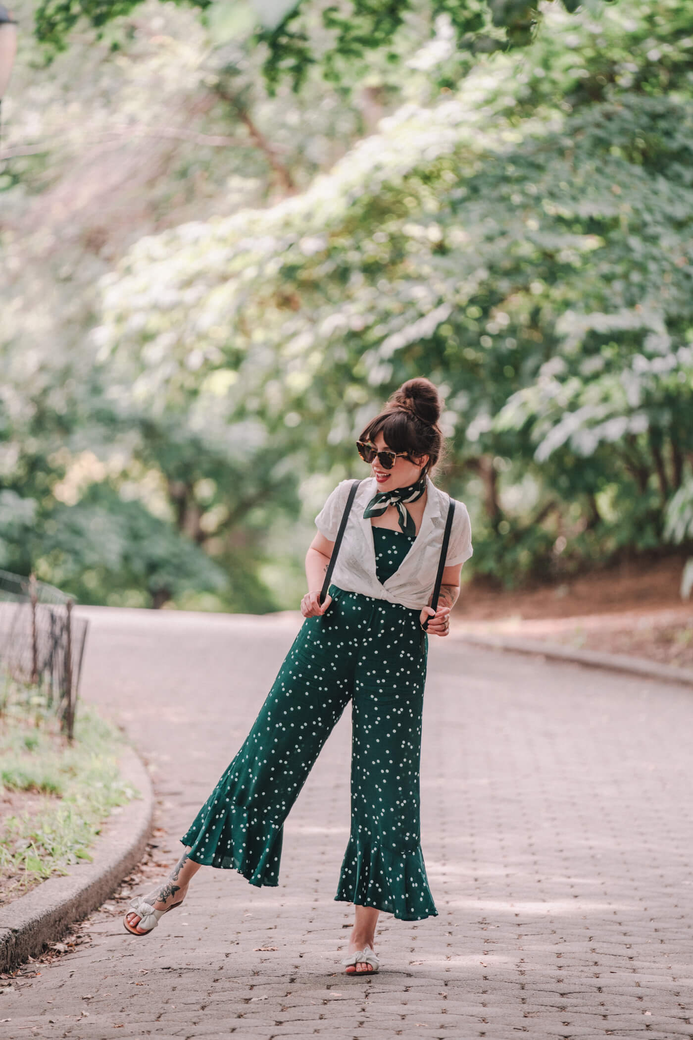 woman wearing green jumpsuit and white shirt