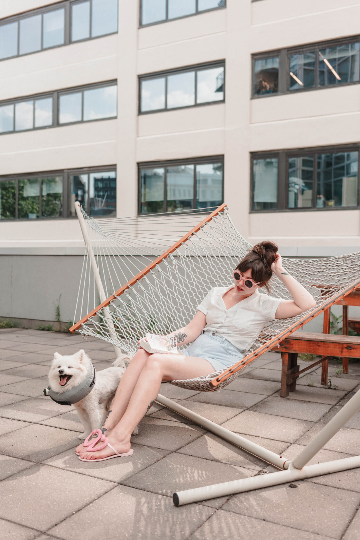 woman sitting down with her pet on a rooftop