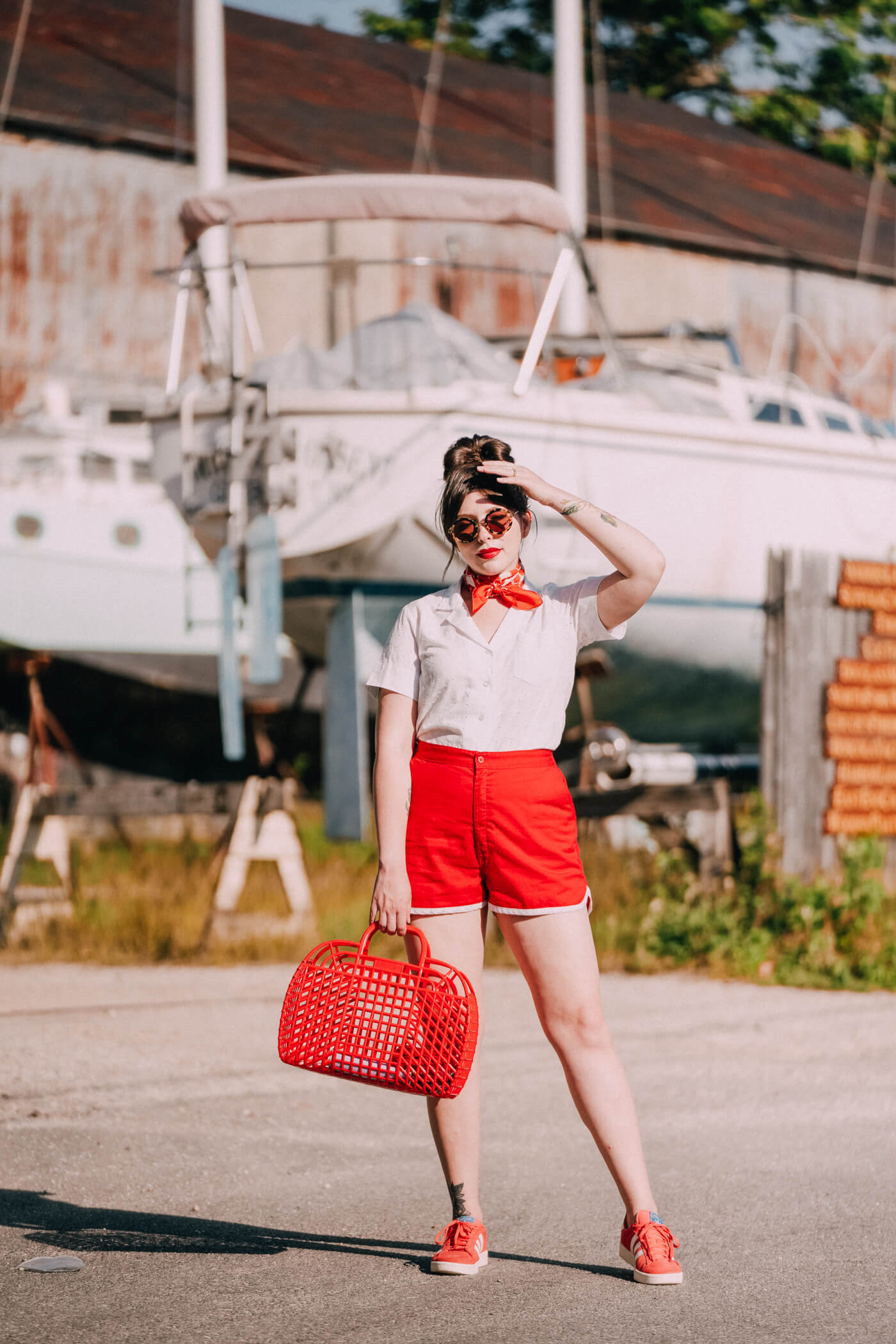 woman wearing white top and red shorts