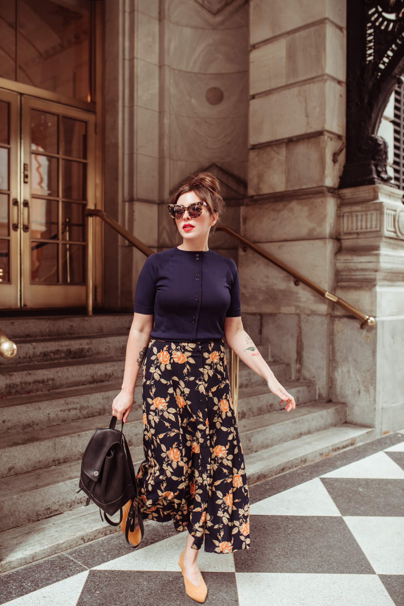 woman wearing printed skirt and blue top