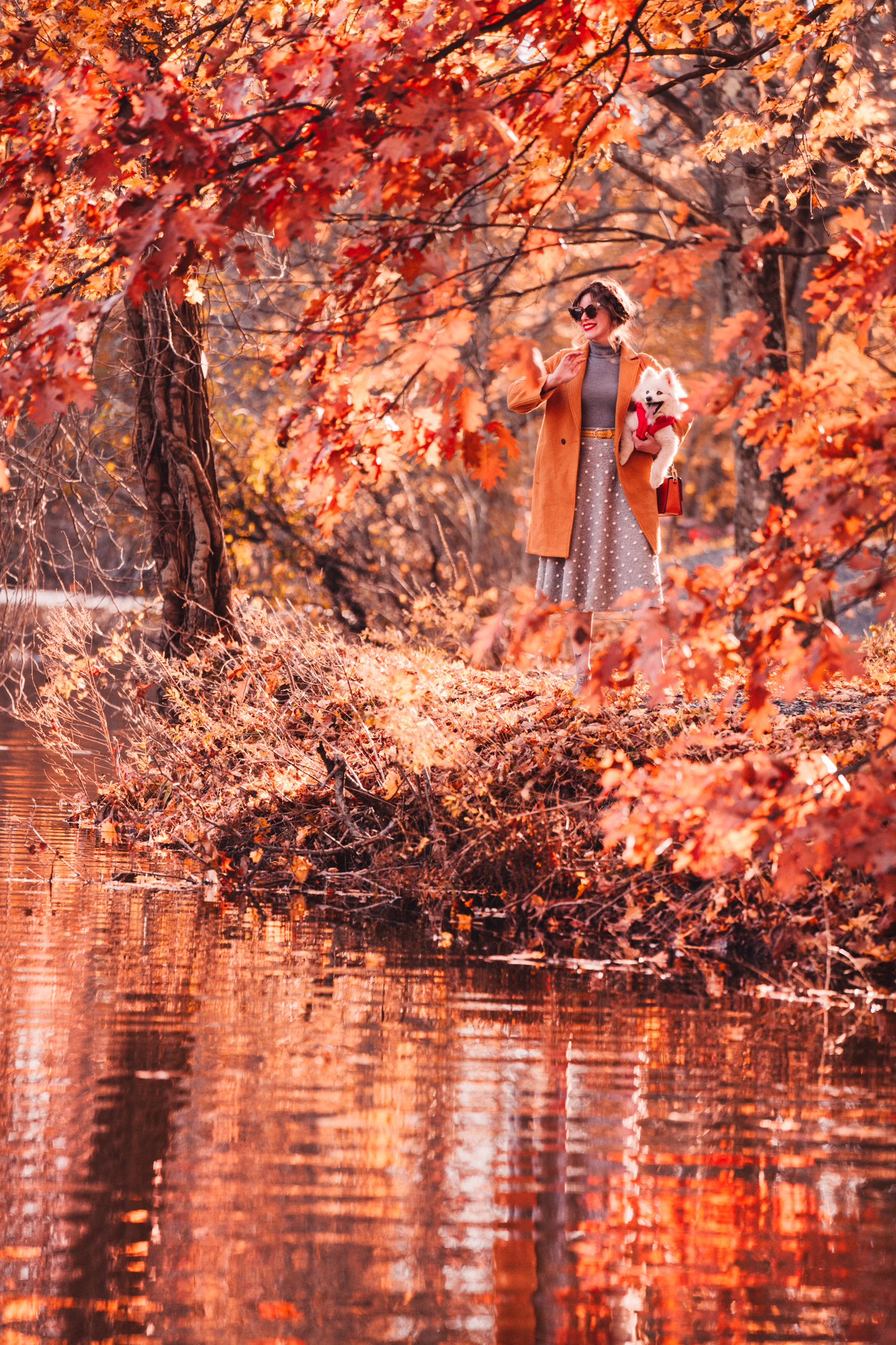 woman outdoors with her dog in autumn