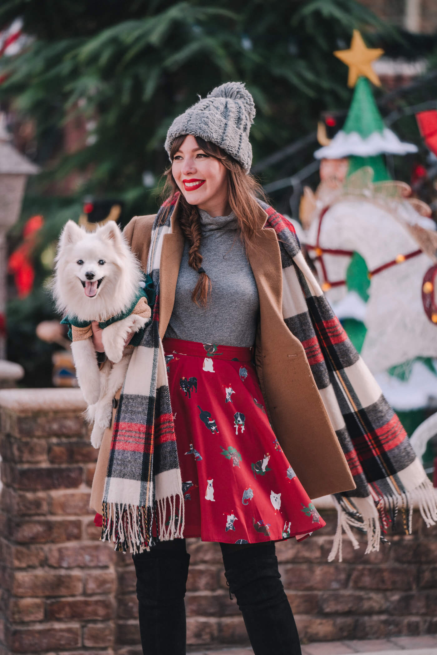 woman with her pet at the Dyker Heights decorations