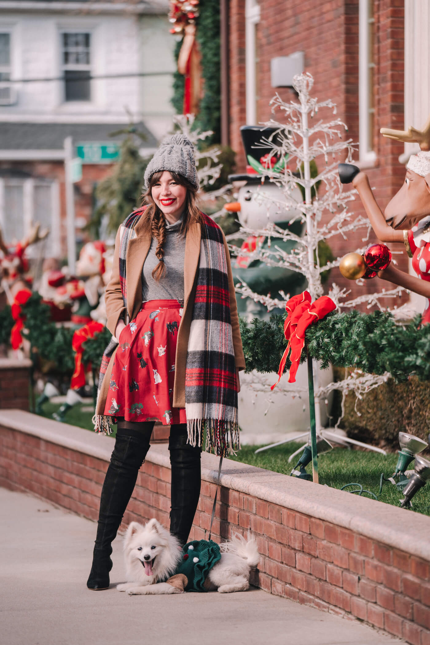 woman at with her dog to see the Dyker Heights decorations