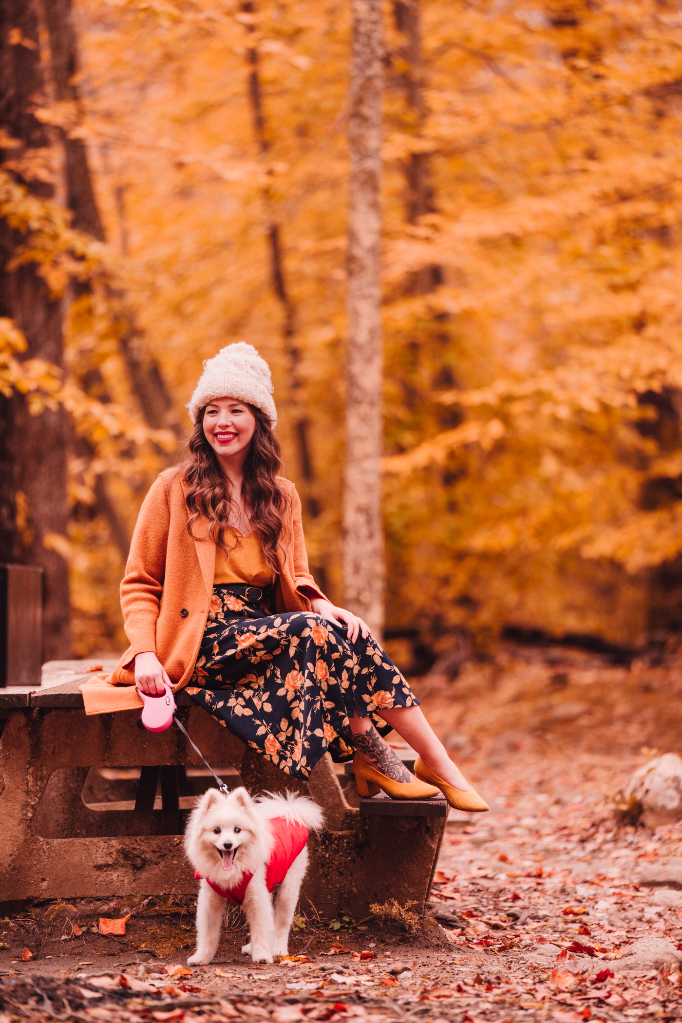 woman sharing Florals and Foliage and holding her dog