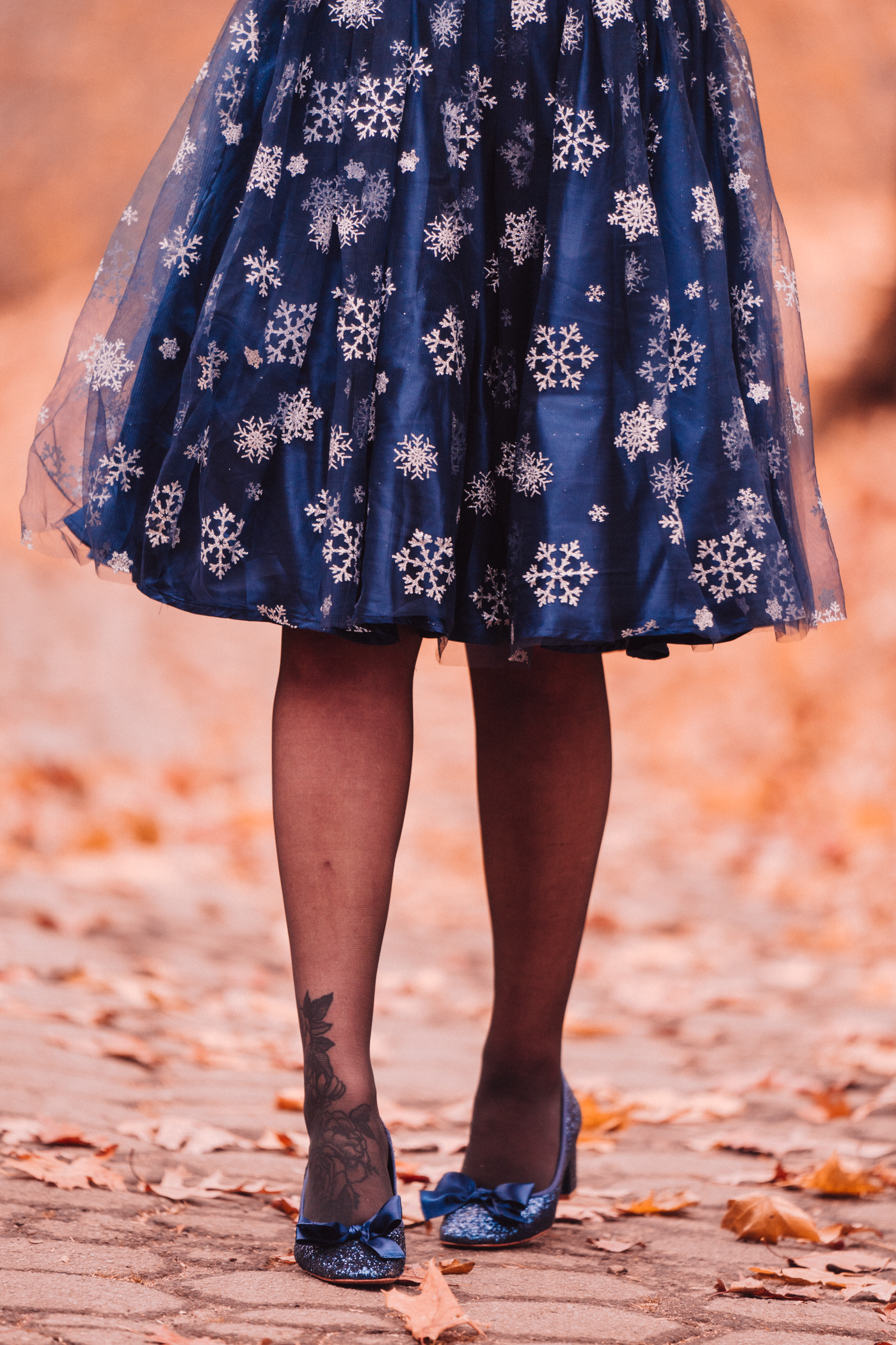 closer look of woman wearing navy snowflake skirt