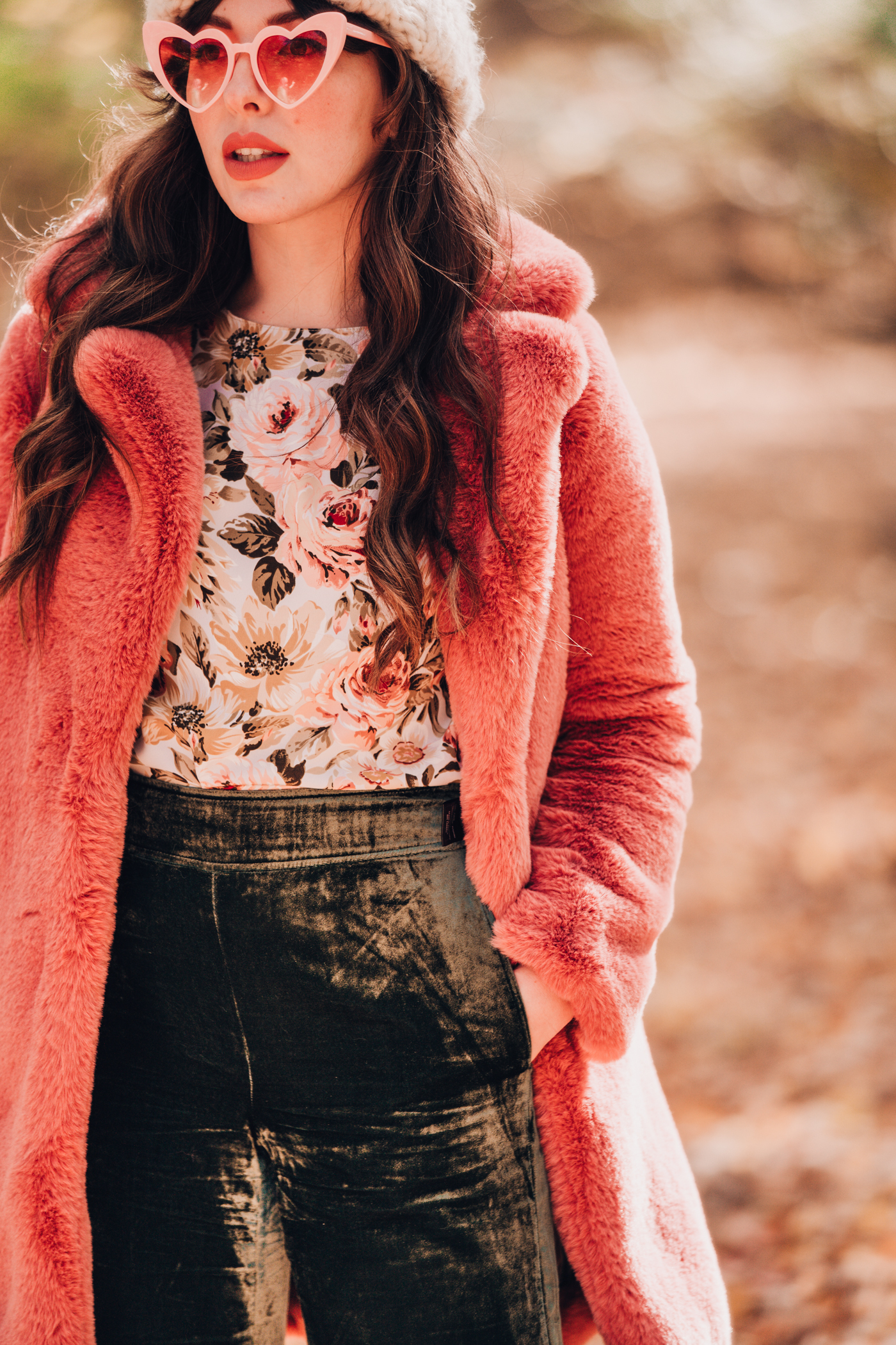 woman wearing Pink faux fur coat floral top 