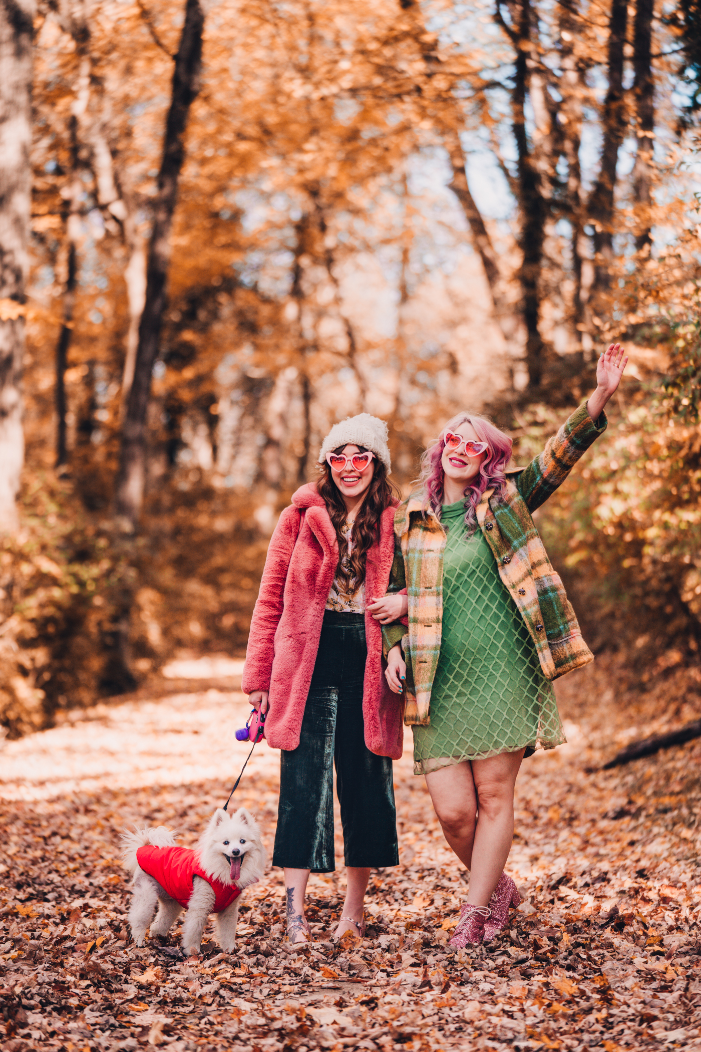 woman in pink faux fur coat and green dress and jacket