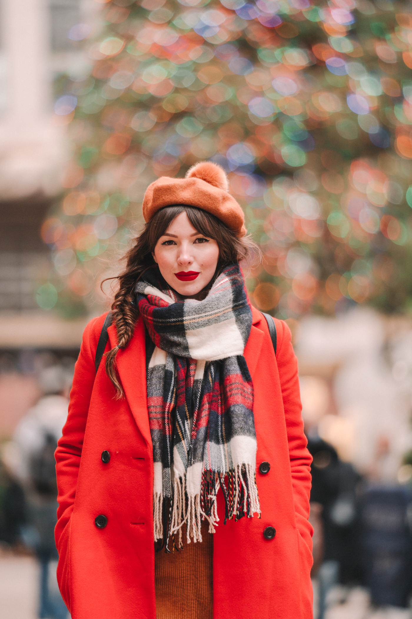 woman wearing red moto jacket and sharing it's beginning to look a lot like Christmas