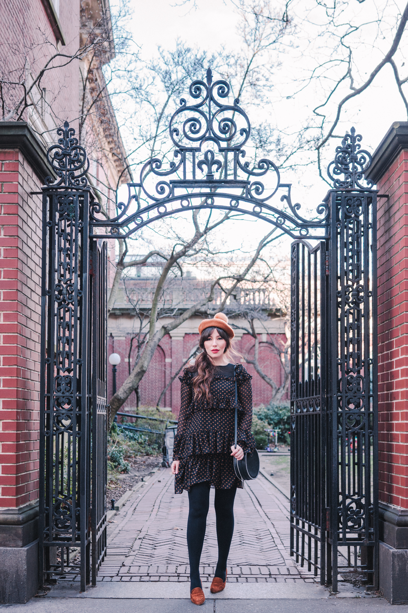 woman wearing Heart print dress and brown hat 