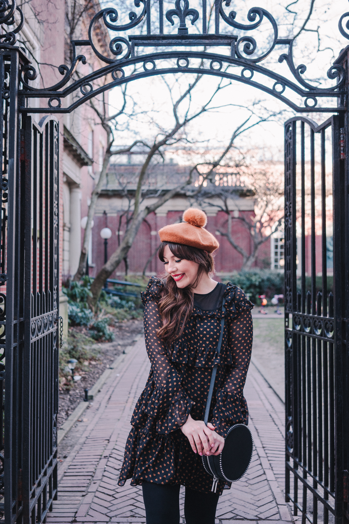 woman wearing Heart print dress and brown sweater 