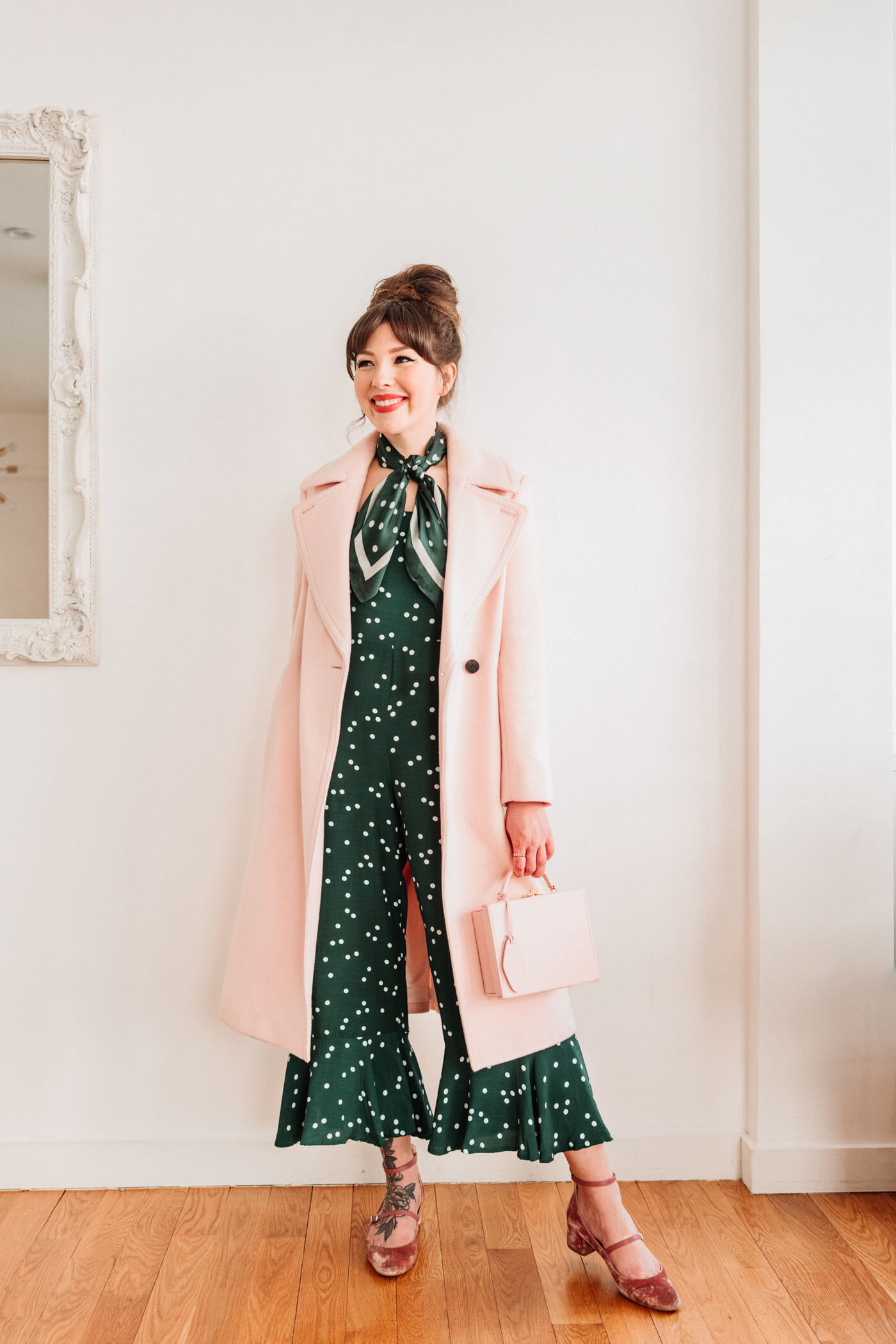 woman in green polka dot jumper and coat 