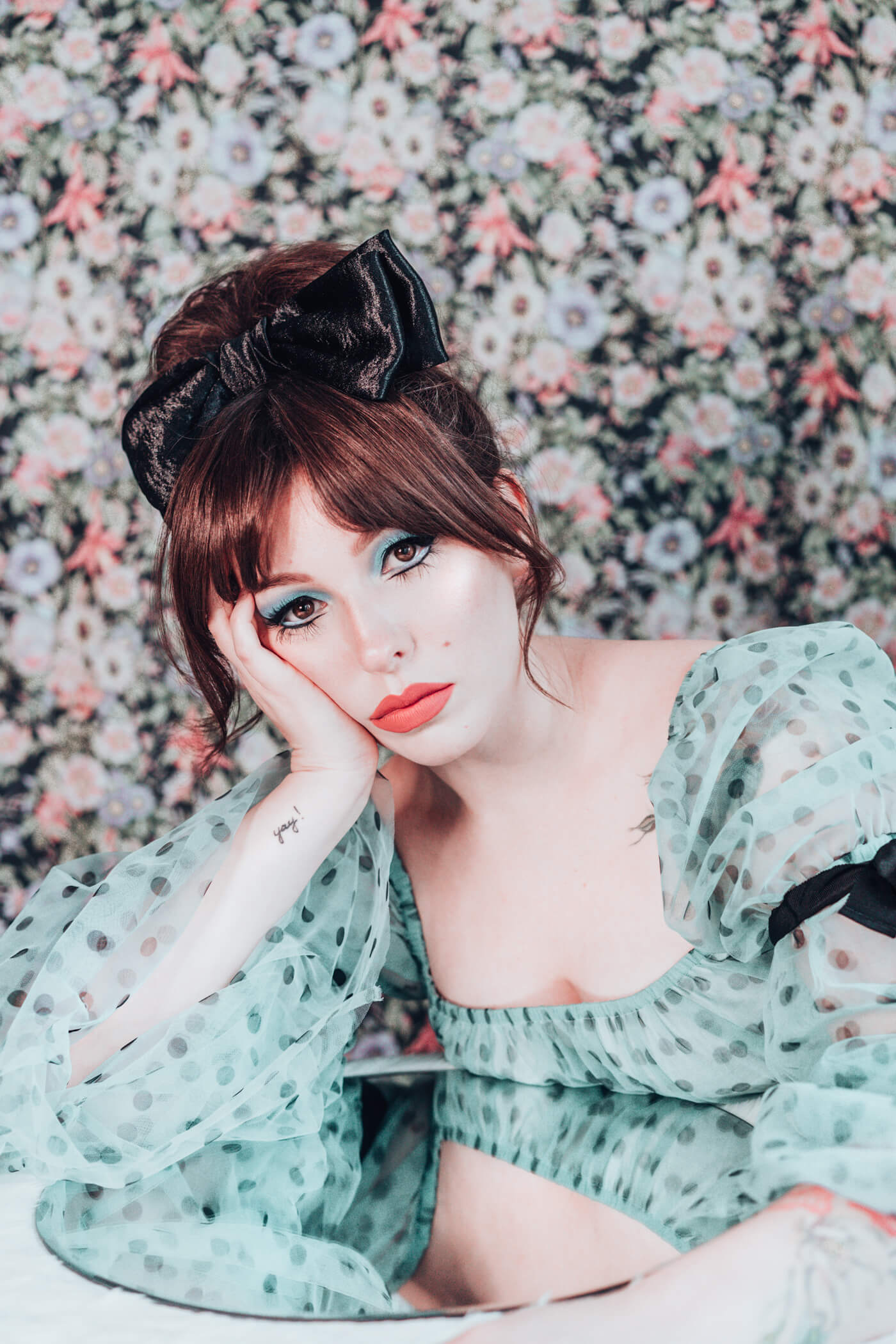 woman wearing polka dot dress and signature eye makeup 