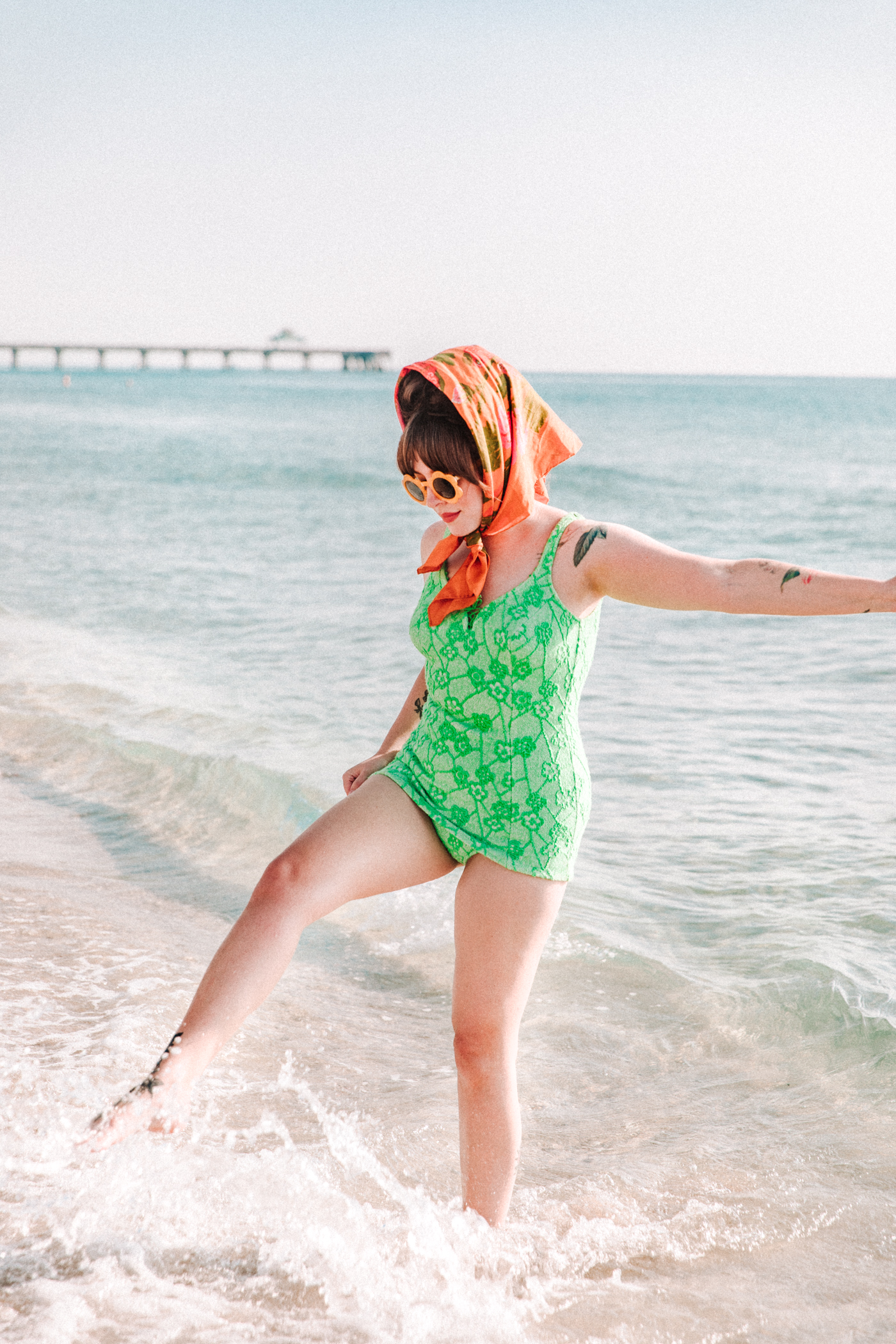 woman wearing neon bathing suit at the beach and sharing adjusting to suburban life