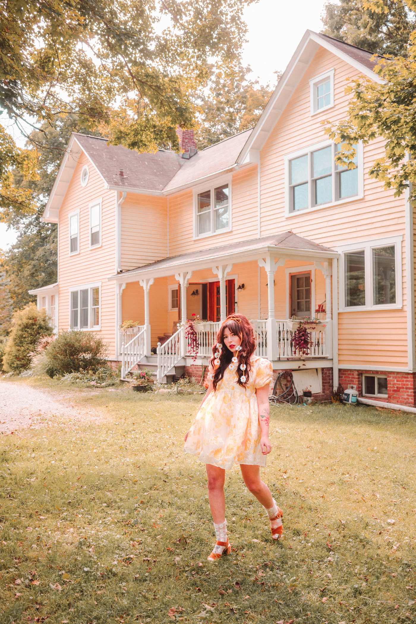 woman outside her home wearing yellow floral dress in One dress, two ways