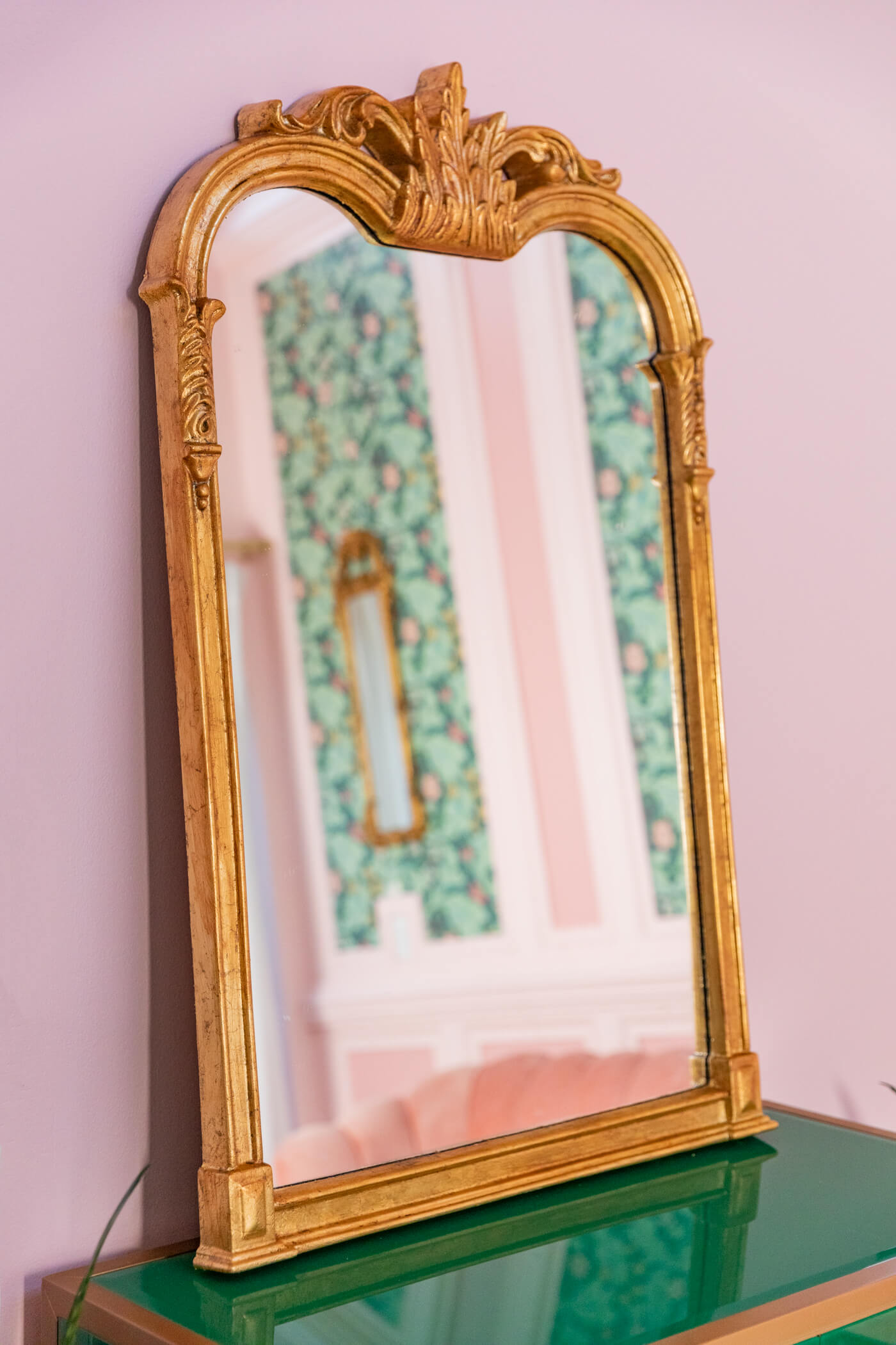 living room with pink velvet mirror and green cabinet 