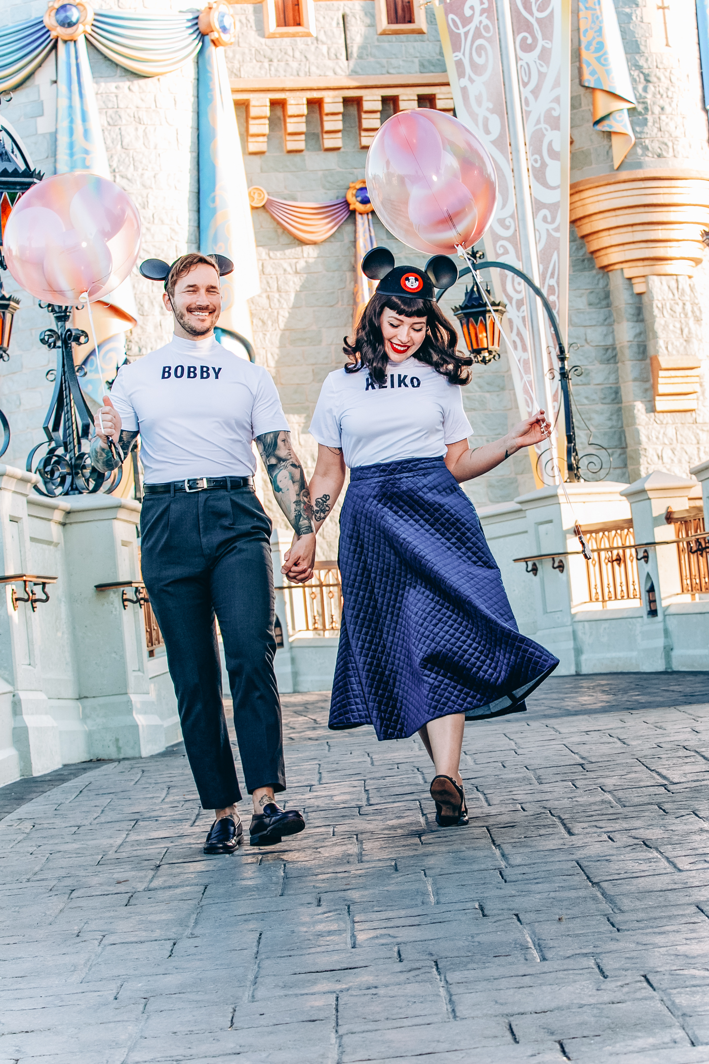 bobby and keiko walking for their private photo shoot at disney