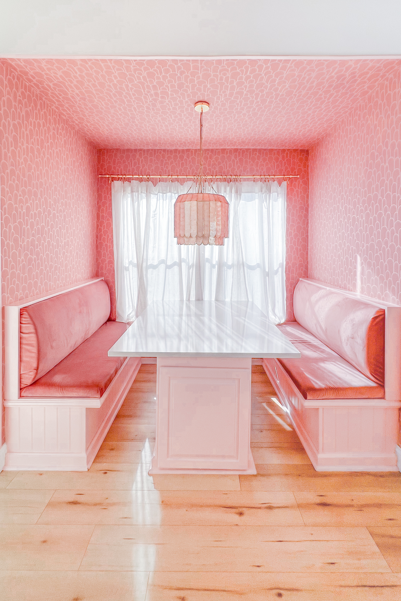 modern art deco inspired pink built in breakfast nook with storage benches by Evelyn Bourdon